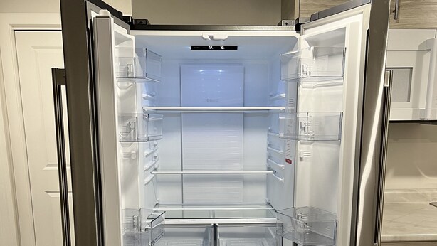 An open refrigerator with multiple shelves and a freezer compartment. - Cozy Private 1-bedroom Basement Suite with free parking (Winnipeg)