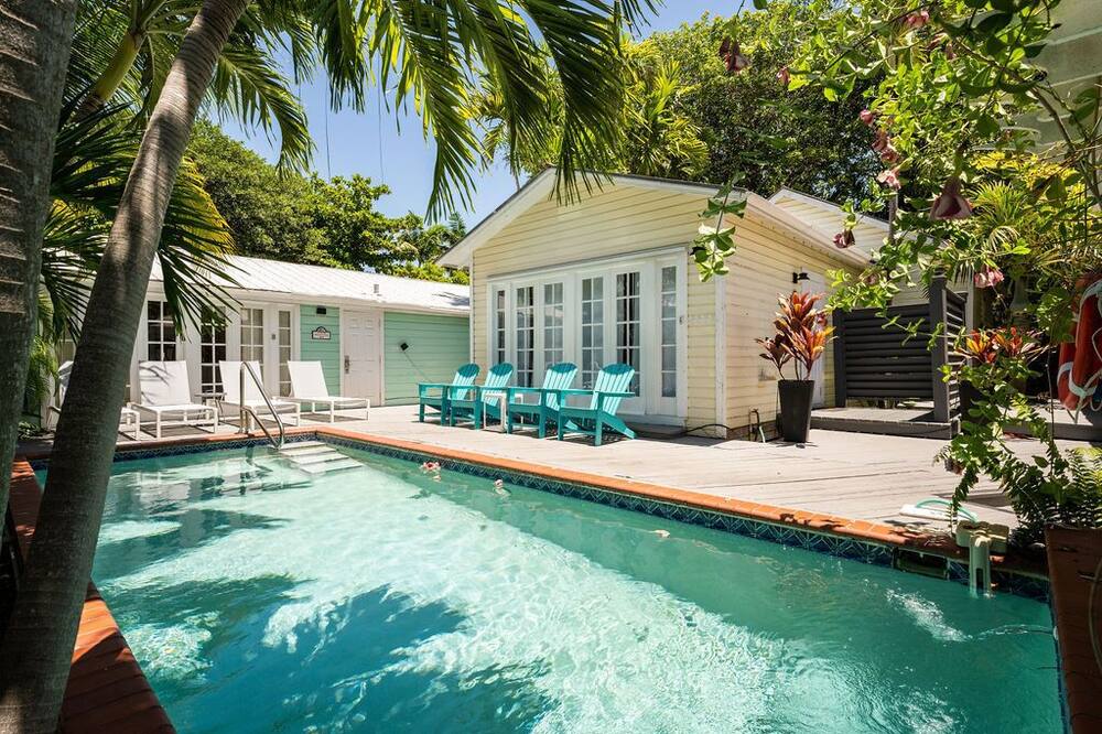 Down a hidden lane in the heart of Old Town Key West you will find “El Secreto.” The compound is located one block off Duval St but is completely private and serene. <br> The compound consists of THREE STAND ALONE COTTAGES alongside a tranquil PRIVATE POOL and connected to each other by a spacious deck. <br><br>The first cottage (610) and second cottage (614) each consist of a one bedroom, one bathroom, open kitchen and living room with high ceilings. The third cottage (616) consists of a one bedroom, one bathroom main house with open kitchen and living room, as well as a detached master bedroom and bathroom. The detached master has an outdoor kitchenette with a mini fridge, sink, coffee maker and dining table. <br><br>All cottages have an updated kitchen with a refrigerator, oven, induction cooktop, coffee maker, toaster, blender and microwave. They also have their own private outdoor patio area with a gas grill, washer and dryer.<br><br>610 and 614 each have one king-size bed and a pull-out sofa capable of accommodating two people. 616 consists of one king-size bed in the main house and one king-size bed in the detached bedroom. <br><br>Outside, you will find a spacious heated pool, lush tropical landscaping, and ample deck space for sunbathing. The compound also has two dedicated off-street parking spaces and plenty of room for bicycles. <br><br>This is a unique property that allows 3 or 4 couples to all stay on the same property while enjoying the comforts of their own private, individual cottages. <br><br>Let us know if you are interested in booking any additional activities such as bicycle rentals, golf carts, boats, fishing trips or any other excursions! Old Town Key West Compound with Pool, Parking and Privacy One Block Off Duval!