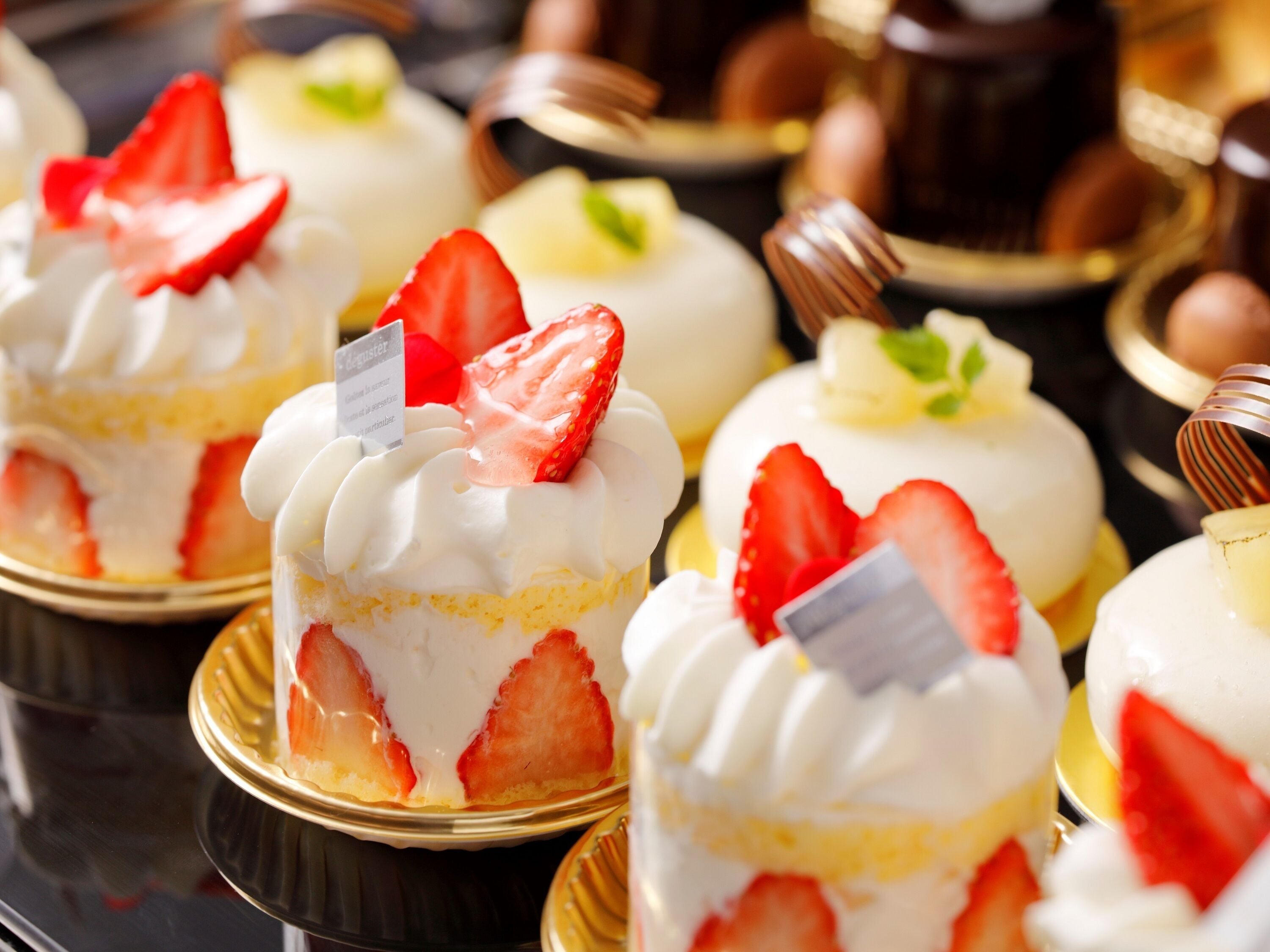 A selection of desserts, including cakes and pastries, arranged on a table.