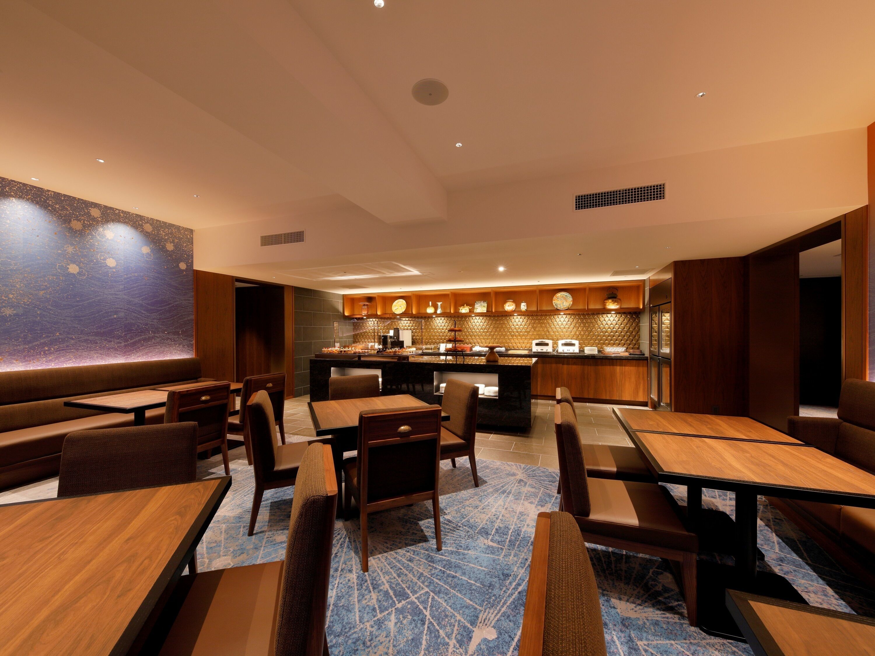 Un restaurante con zona de bar, muebles de madera y pared con diseño.