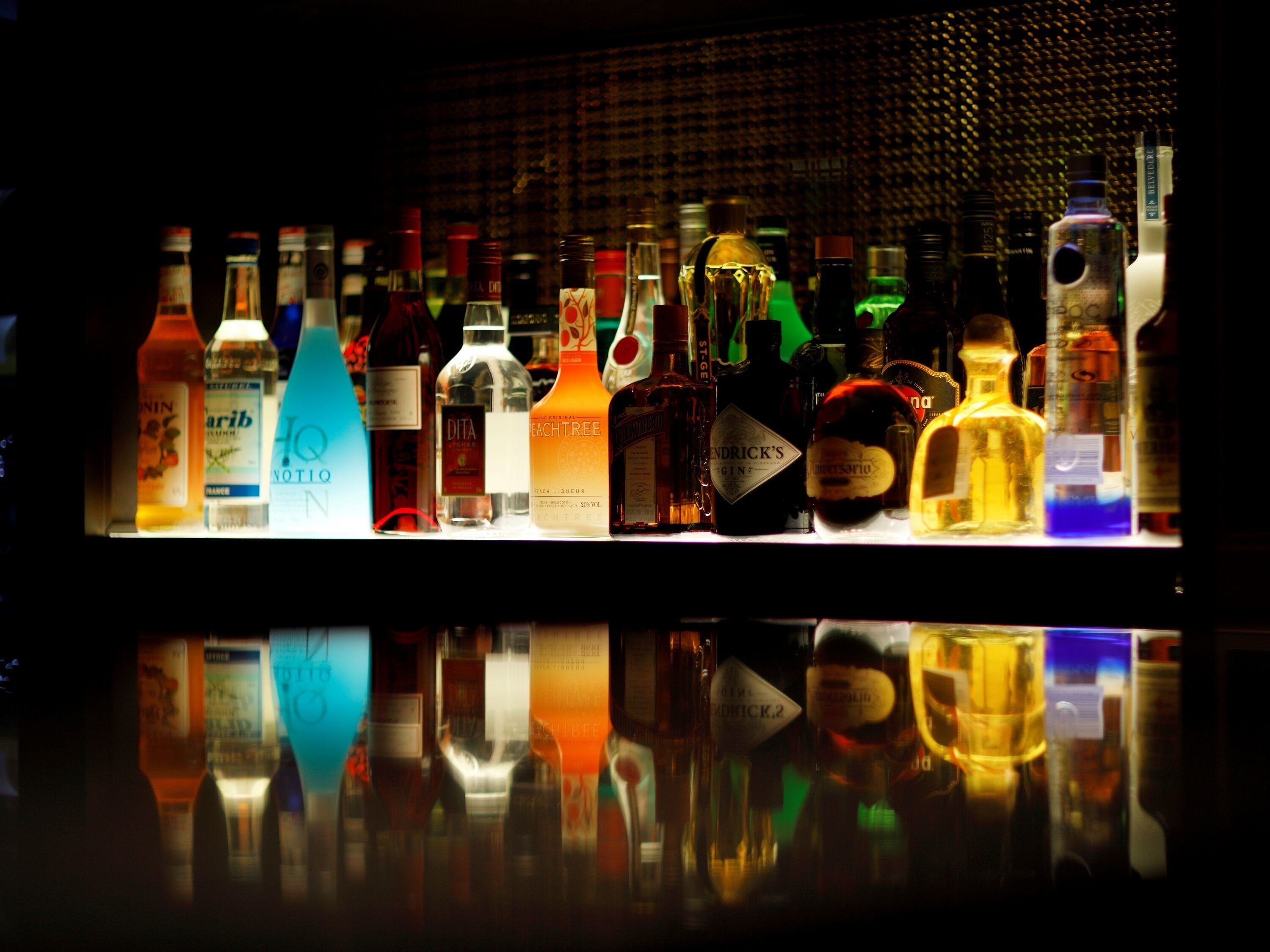 A bar with various bottles of liquor displayed on shelves.