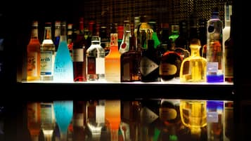 A bar with various bottles of liquor displayed on shelves.