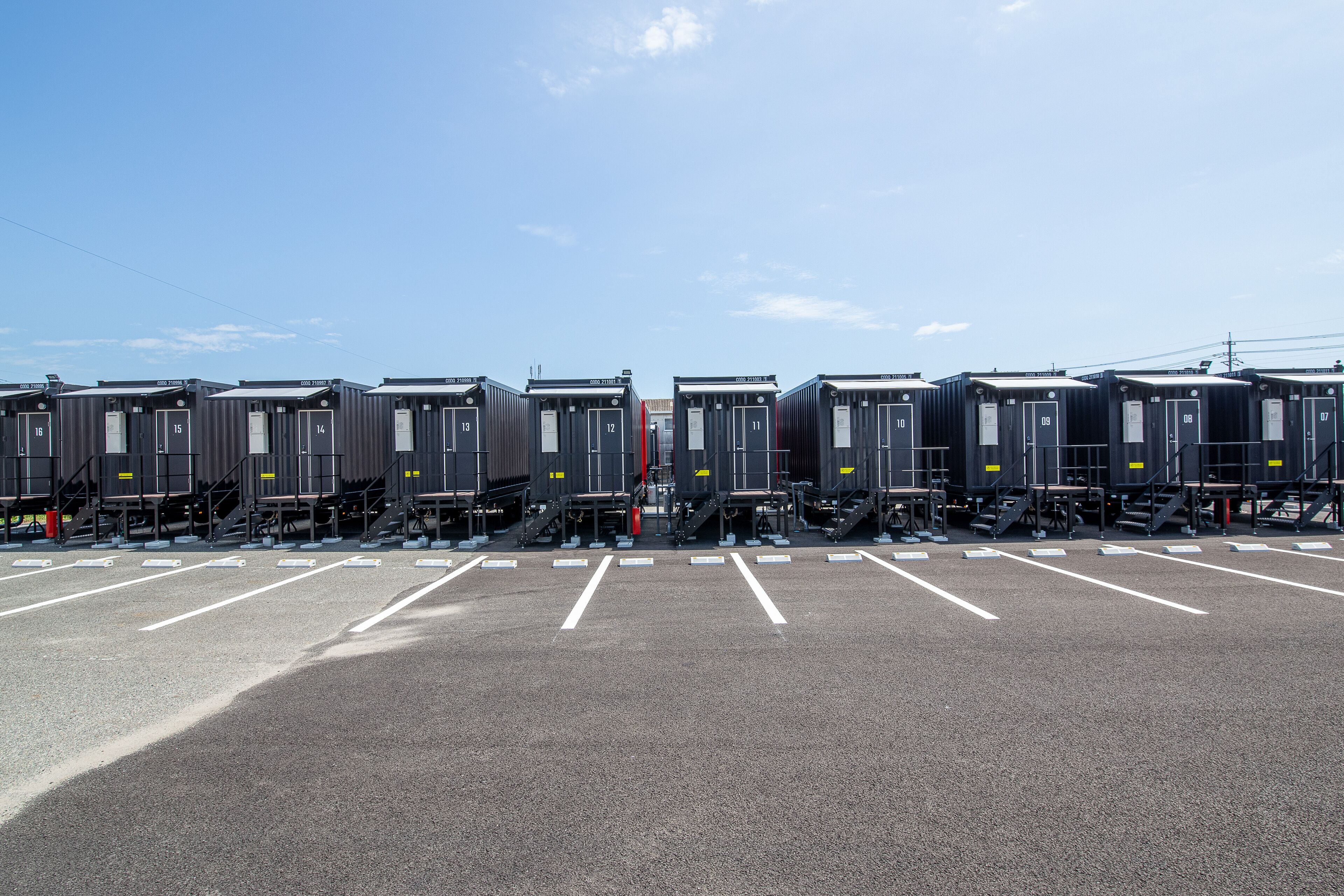 A parking lot with rows of train carriages.