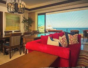 Relax in comfort with a spacious layout, a sofa, coffee table, and dining area, all with a stunning ocean view.