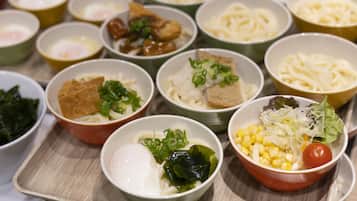A variety of bowls containing different types of food, likely a meal or buffet spread.