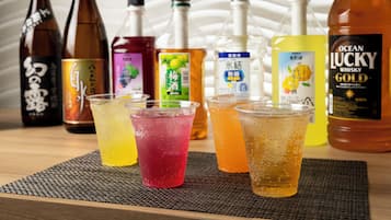 A table with various beverage bottles and glasses.