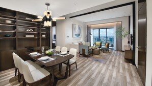 A modern living room with a dining area, large windows, and a city view. - Oakwood Residence Foshan (Foshan)