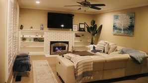 A living room with a fireplace, a sofa, a coffee table, and a ceiling fan. - Casa Esperanza. Peaceful Get-away W/Hot Tub. (Salinas)