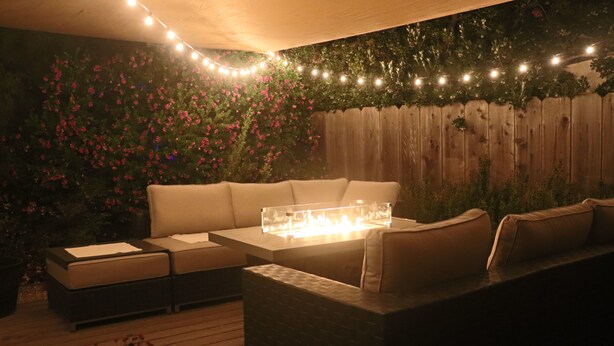 An outdoor seating area with a fire feature, wooden deck, and string lights. - Casa Esperanza. Peaceful Get-away W/Hot Tub. (Salinas)