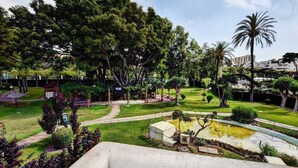 A park with a picnic area, a pond, and a pathway.