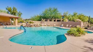 A pool area with lounge chairs and a covered seating area. - Completely Remodel Condo, Sleep Number I-8 bed with adjustable firmness. (Cave Creek)