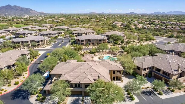 A residential area with multiple houses, a swimming pool, and a mountain in the background. - Completely Remodel Condo, Sleep Number I-8 bed with adjustable firmness. (Cave Creek)