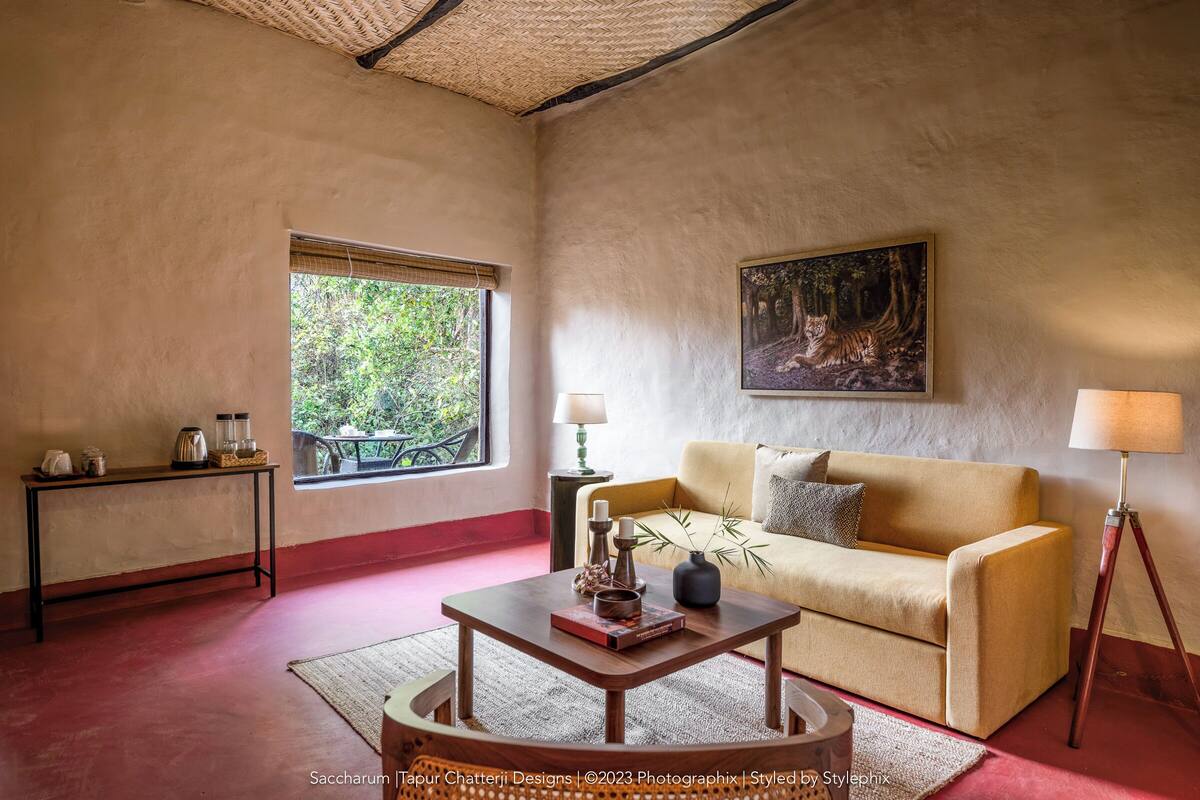 A cozy living room with a sofa, coffee table, and a painting on the wall.