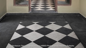A hallway with a checkered floor leading to a room with a wooden bench and two wall-mounted lamps. - Saccharum Safari Lodge (Baihar)