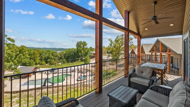 A covered outdoor deck with wicker furniture, a pool, and a view of the surrounding landscape. - Private HotTub - Pool Front - Boat Slip Included (Branson)