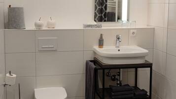 Shower, towels, soap, toilet paper