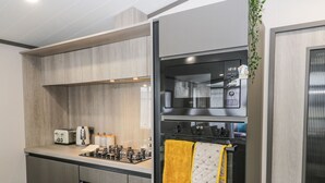 A modern kitchen with a built-in oven, a toaster, and a sink. - 59 Finch (Scarborough)