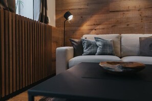 A modern living room with a sofa, a coffee table, and a floor lamp.
