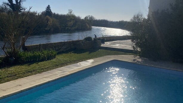 A swimming pool with a view of a river and trees. - House with private pool and jacuzzi, panoramic river view (La Force)