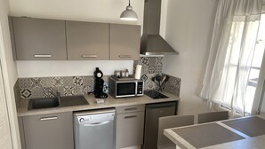 A compact kitchen with a dishwasher, a microwave, and a coffee maker. - House with private pool and jacuzzi, panoramic river view (La Force)