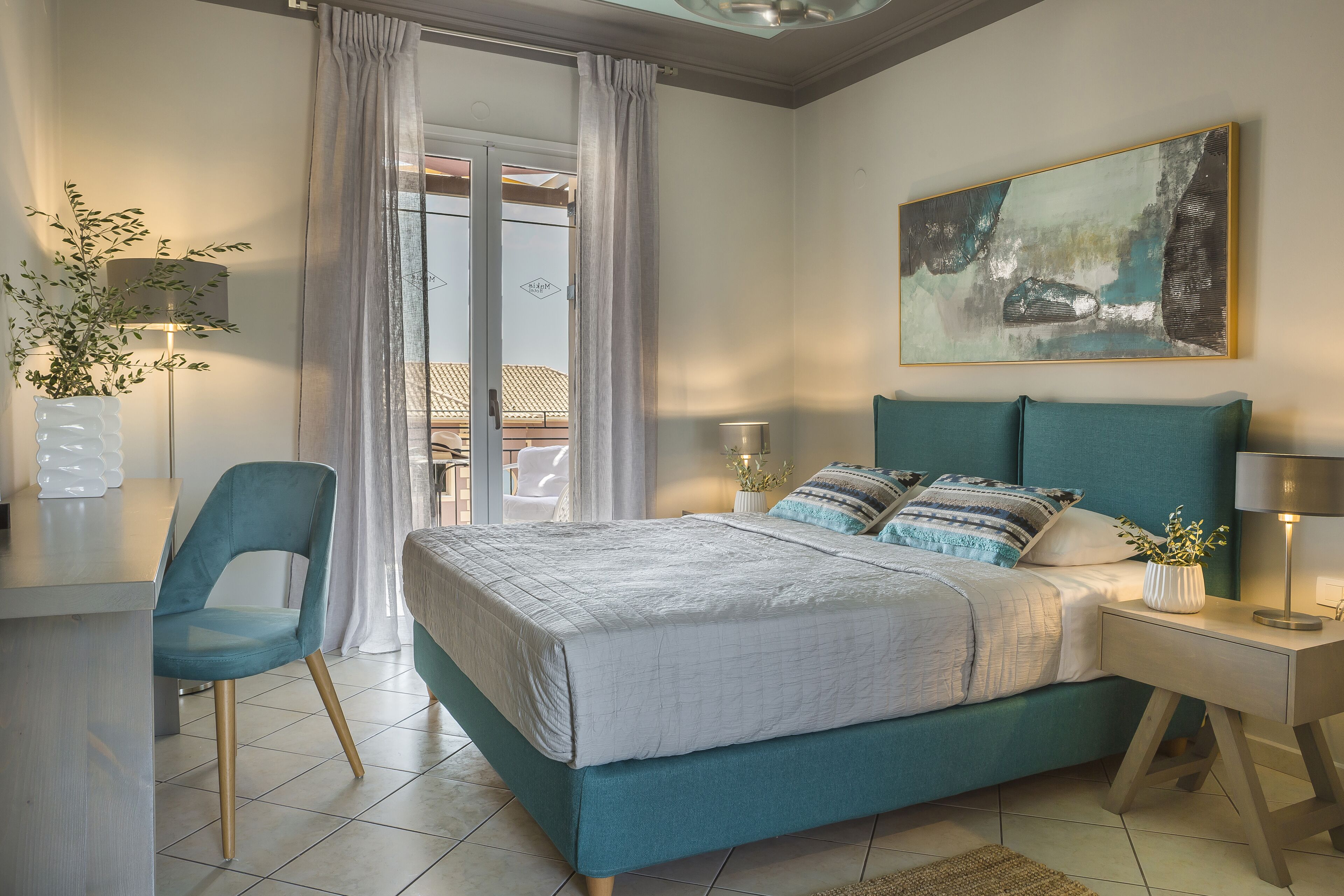 A bedroom with a bed, a desk, a chair, a nightstand, and a painting on the wall.