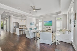 A spacious living area with a kitchen, dining area, and seating space.
