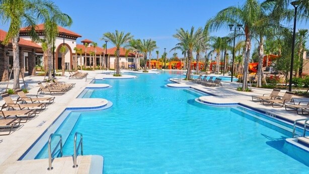 A large outdoor swimming pool with multiple lanes, surrounded by palm trees and lounge chairs. - Amazing 4br Resort Townhome W/ Splash Pool-4686td 4 Bedroom Villa by RedAwning (Davenport)