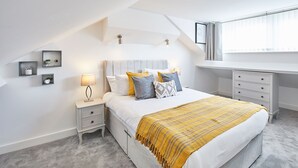 A bedroom with a bed, nightstands, a desk, and a window. - Host & Stay | Morgan's Rest (Scarborough)