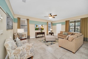 Relax in this inviting living room with a sofa, loveseat, and chair, plus a coffee table and side table.
