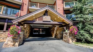 A multi-story building with a sign reading "Sawmill Creek Condominiums."