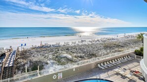 A beach view from a balcony with a pool, a sandy beach, and a clear sky. - 407 Island Princess~3BR 3Ba Gulf front with Balcony~FREE Beach Service (Fort Walton Beach)