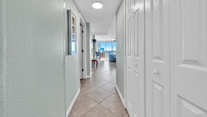 A hallway with a view to a balcony and a kitchen area. - 407 Island Princess~3BR 3Ba Gulf front with Balcony~FREE Beach Service (Fort Walton Beach)