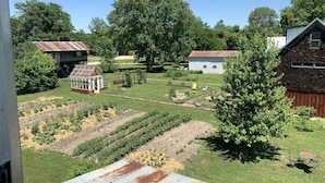 A rural landscape with a greenhouse, wooden buildings, and a well-maintained garden. - Step Back in Time Near The Missouri River (Jamestown)