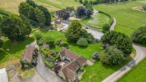 An aerial view of a residential area with houses, roads, and surrounding greenery. - The Anchorage @ Nables Farm (Chippenham)