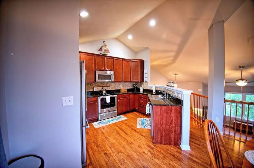 A spacious kitchen with wooden cabinets, stainless steel appliances, and a large island.