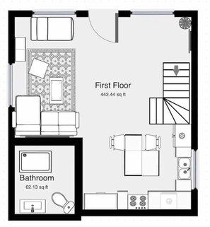 Planimetria al primo piano con zona living, parete decorata, scala, cucina e bagno.