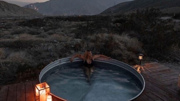 Ein Whirlpool auf einer Holzterrasse mit Bergblick.