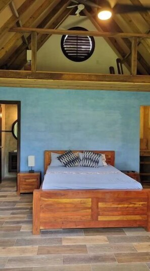 Relax in this serene bedroom with a comfortable bed, window with blinds, and ceiling fan.