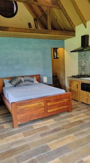 Cozy retreat with a wooden bed, sloped ceiling, and skylight.