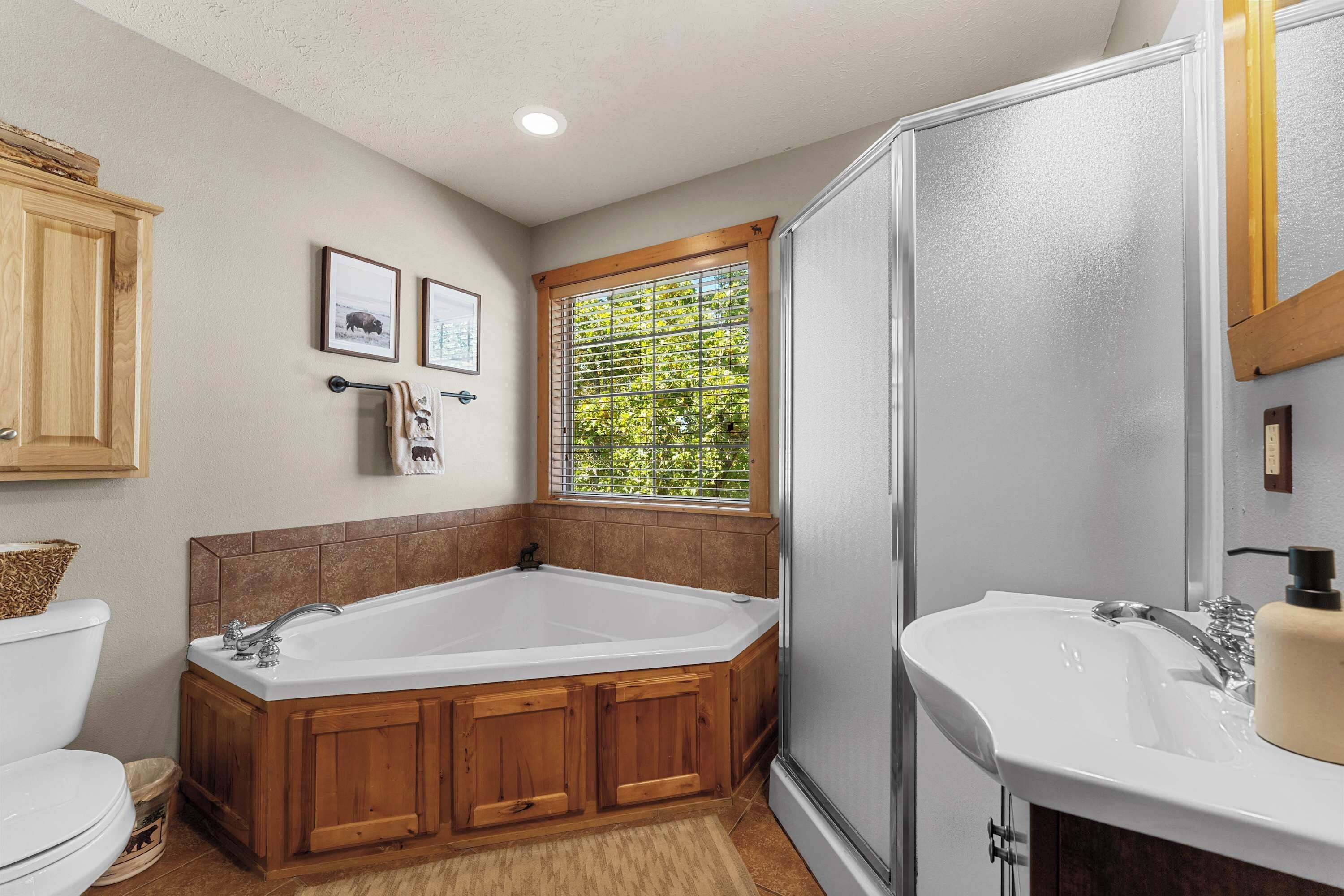 A bathroom with a bathtub, a shower, a toilet, and a sink.