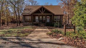 A lodge with a stone facade, a front porch, and a sign indicating 'Lodge 101'. - Cedar Ridge Cabin, Stonebridge Village (Branson West)