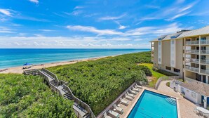 A hotel with a pool, beach view, and a lush green landscape. - Oceanfront Condo Located in Paradise on S. Hutchinson Island/Stuart 
 (Stuart)