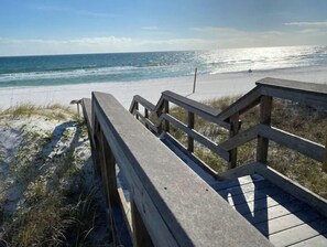 A wooden boardwalk leading to a beach with sand dunes and ocean views. - Close to beach & Steps to pool = AMAZING VACATION! (Miramar Beach)