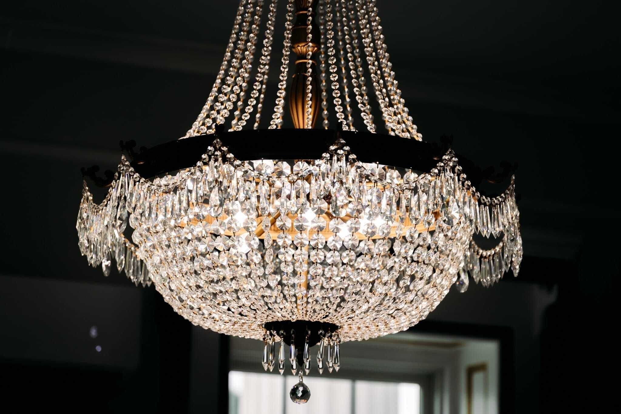 A chandelier with multiple tiers of crystals and a central column.