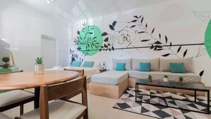 Una sala moderna con sofá, mesa de centro y mesa de comedor.