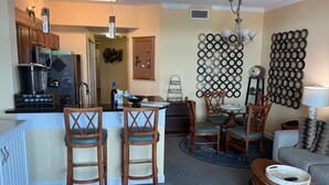 A compact living space with a kitchen, dining area, and seating.