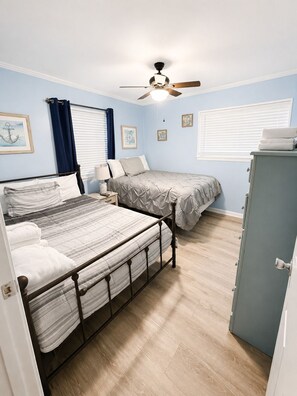 A bedroom with two beds, a ceiling fan, and a dresser. - Hilton Head Island Beach & Pickleball Getaway (Hilton Head Island)
