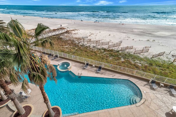 A swimming pool with a view of the beach and ocean.