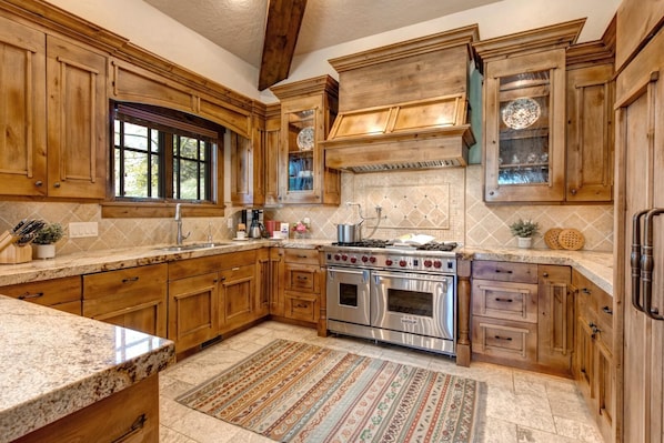Features a stove and oven, sink, and ample storage.