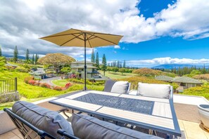 Relax in a serene outdoor space surrounded by lush greenery and a beautiful golf course view.